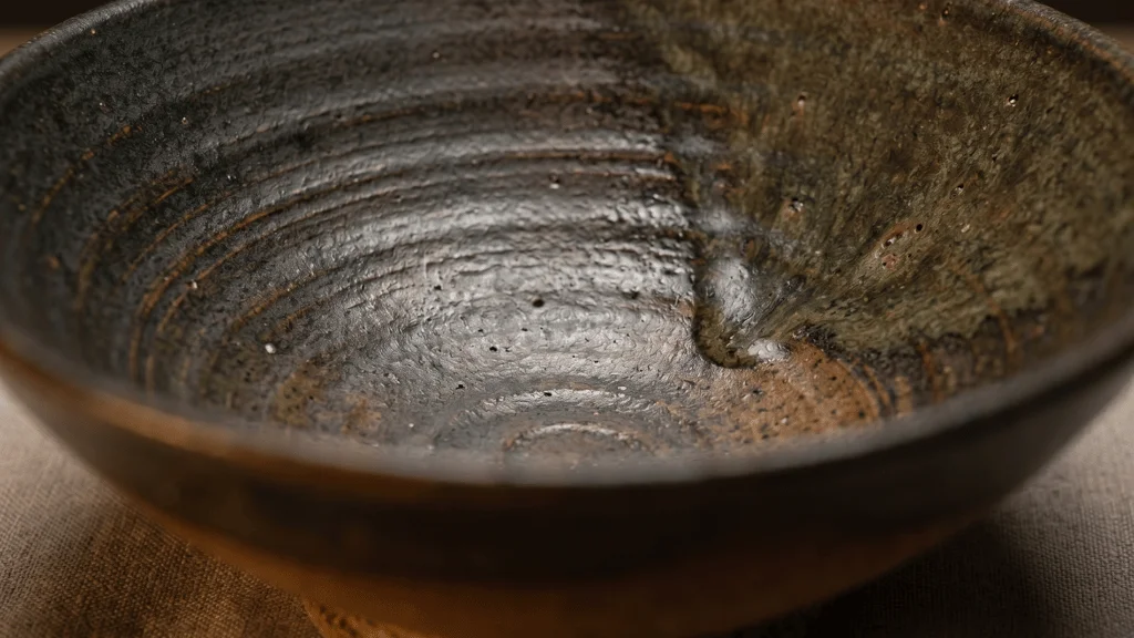 Textured earth-tone tableware styled for a modern restaurant table