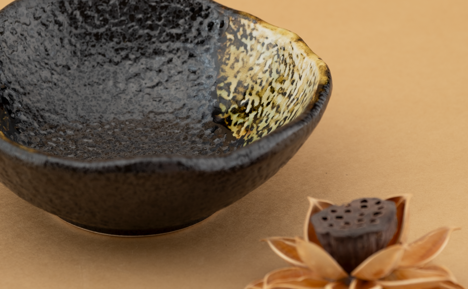 Eclipse Stone rectangular tray with a black textured glaze breaking to amber along a hard diagonal edge