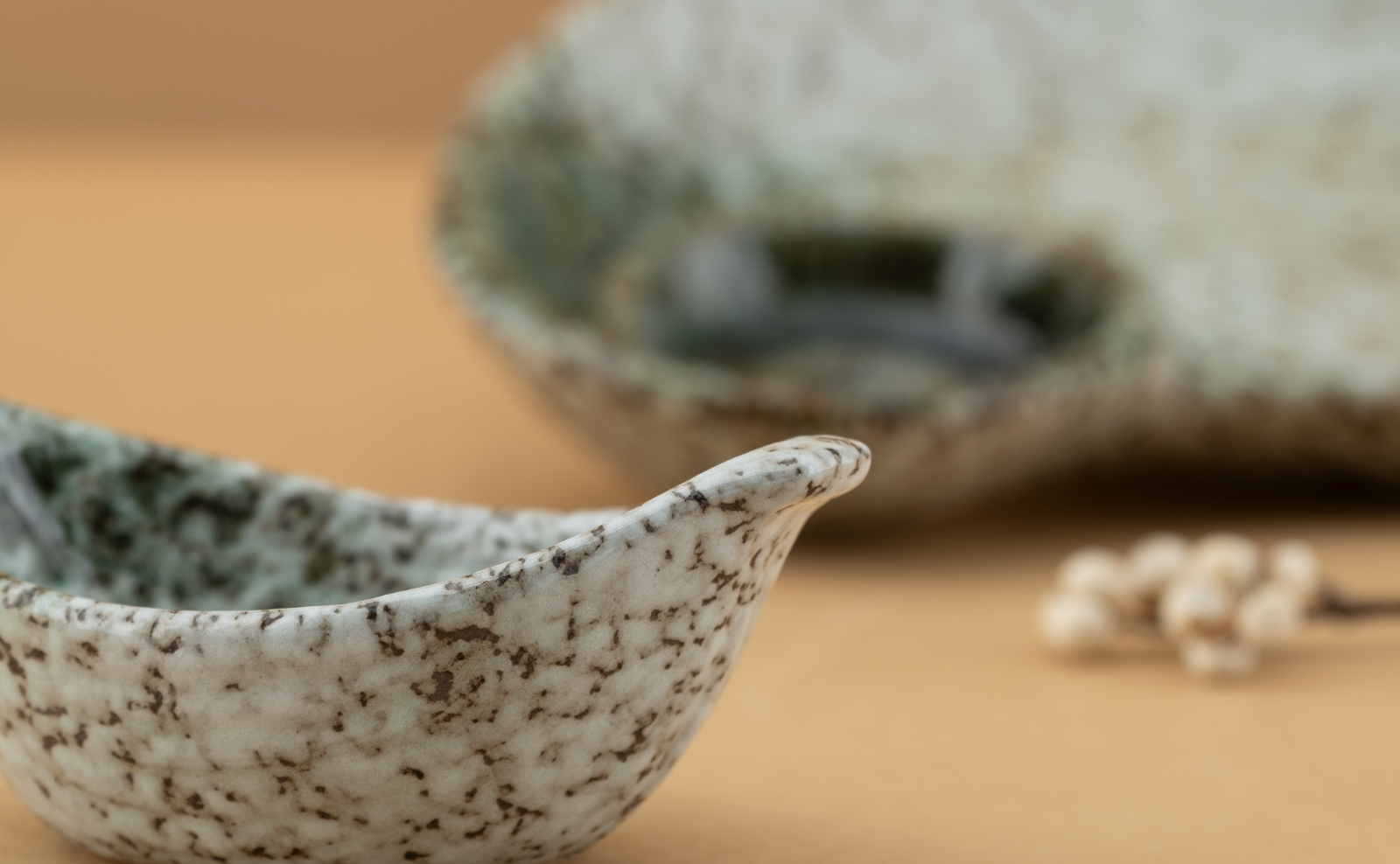 Emerald Coast organic-shaped bowls in speckled stoneware with mossy green wells
