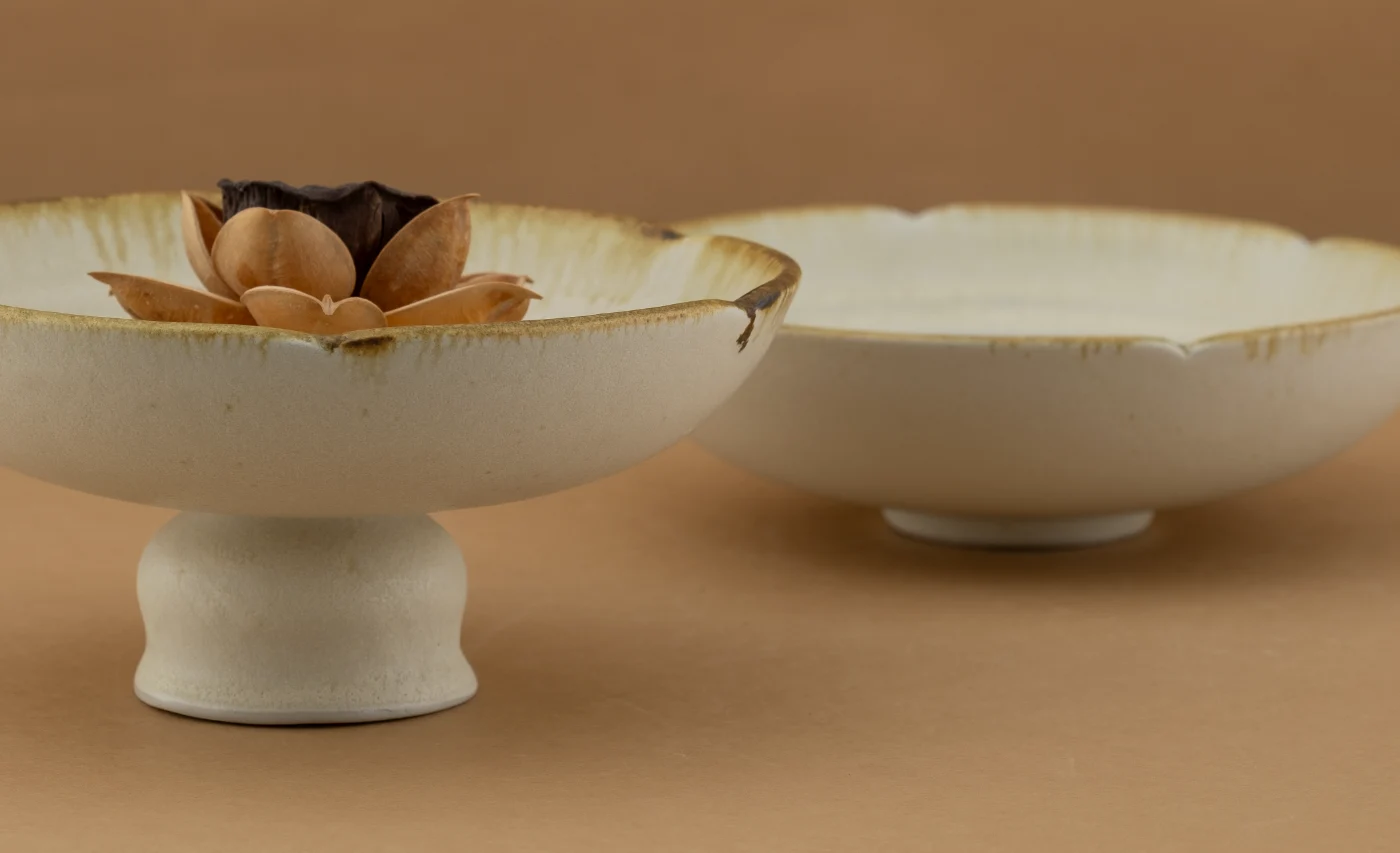 Two Golden Whisper footed bowls in warm ivory with amber rims